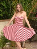 Wearing a red candy cane print dress Carly Kaleb gives the hot pussy shots and lets her tits swing.