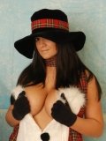 Elegant brunette Southern Brooke in hat puts her gloved hands on her big tits and shows her ass