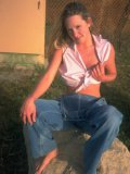 Shaved pussy chick Alexis Malone in jeans and thong does striptease in the field