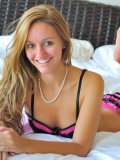 Chandler Fay in beautiful pink and black lingerie exposes her slit on the bed