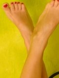 Blonde Helena Sweet with breathtaking legs squeezes thick dildo between her feet