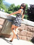Ann Angel in pretty short summer dress exposes her legs and flashes her panties outdoors