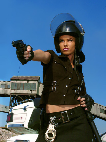 Sexy police babe Marketa B with ultra long legs shows her boobs in the sun.